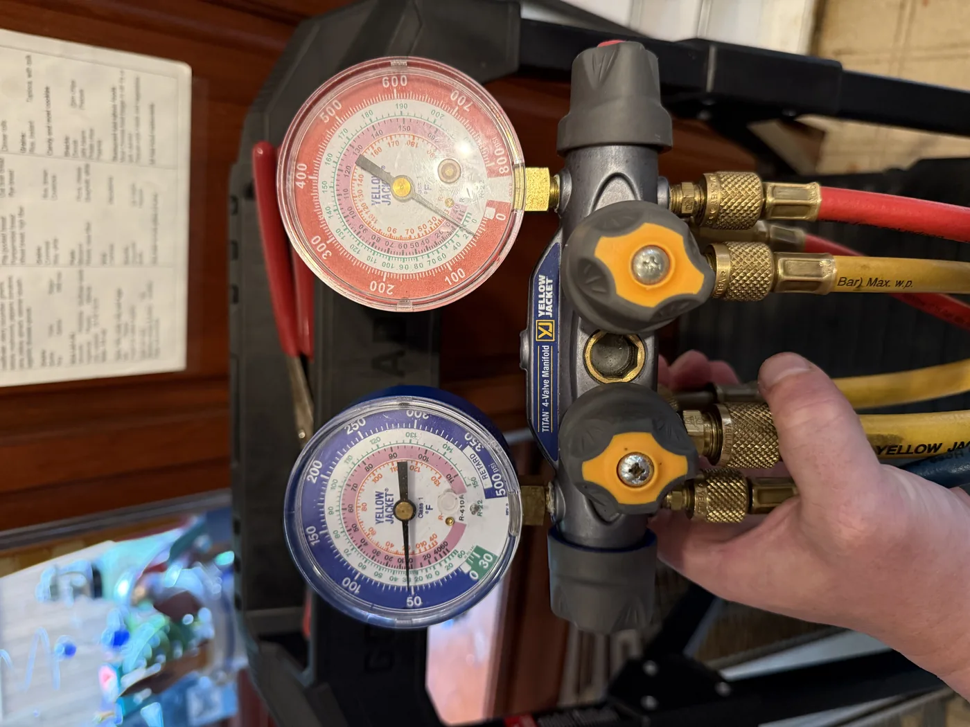 Refrigeration diagnostic gauge set held during service
