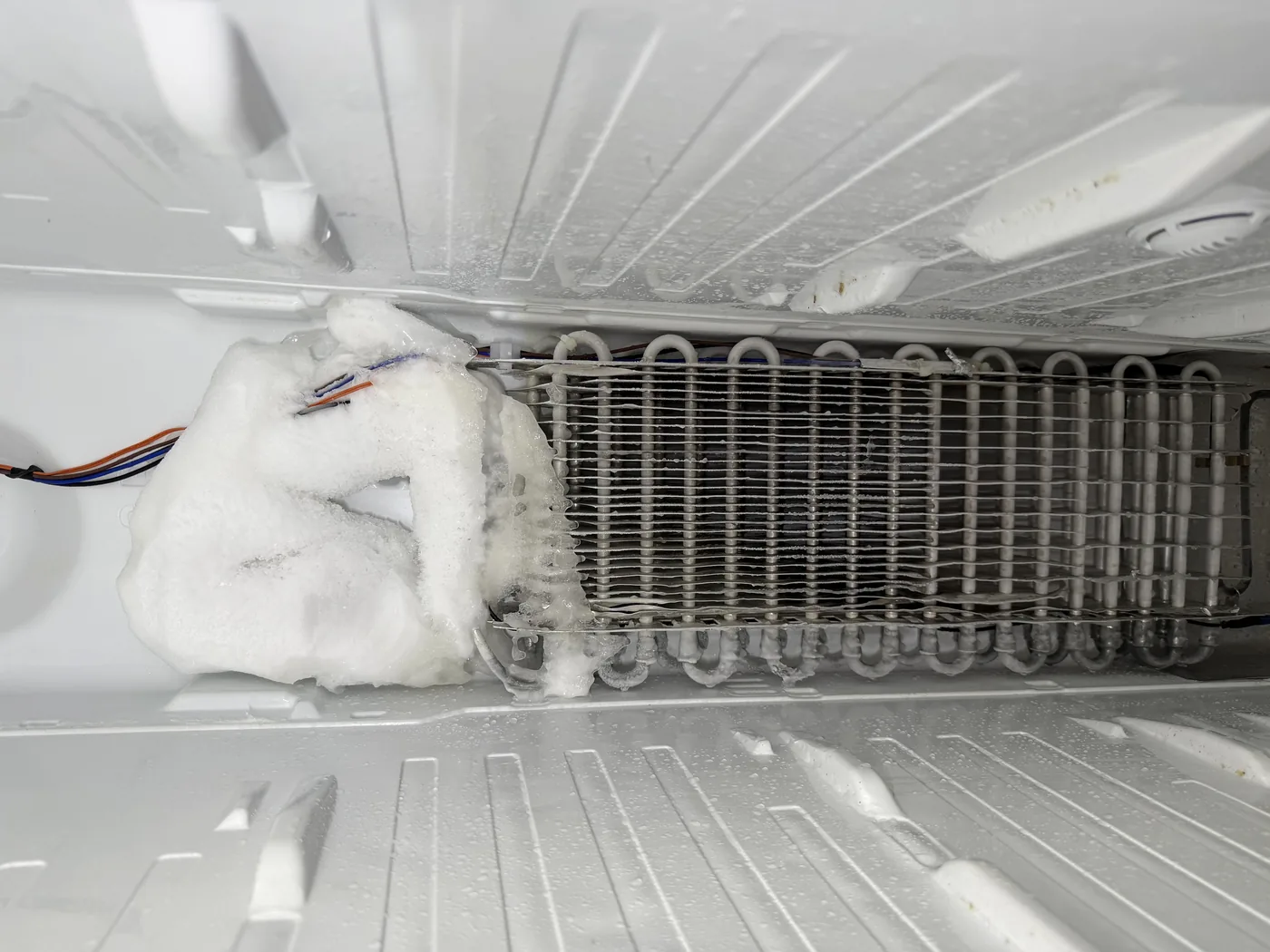 Heavy frost around a freezer evaporator coil